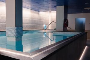 a swimming pool with a person in the water at Albergo Parco Gran Sasso in Castel del Monte