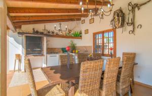 a kitchen with a dining room table and chairs at Can Bleio in Pollença