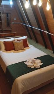 a bedroom with two beds with flowers on it at Refúgio Bocaina in Bocaina do Sul +60 photos