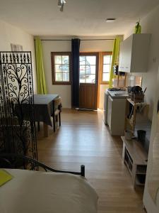 a living room with a kitchen and a dining room at L'Abbatiale in Néris-les-Bains