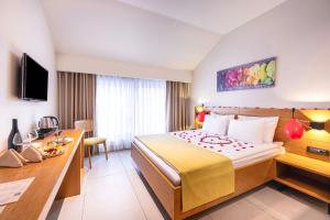 a hotel room with a bed and a desk at Lei Hotel in Antalya