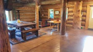 a room with a table and chairs in a log cabin at Spectacular Large Group Accommodations With Gallatin River Access! in Bozeman