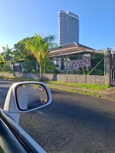 a side view mirror of a car on the road at Berry Cottage in Suva