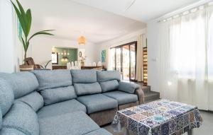 a living room with a blue couch and a table at Corazon in Canyamel +34 photos