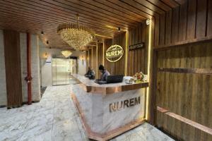 a lobby of a hotel with a nirim counter at Nurem Hotel and Resort in Lalru