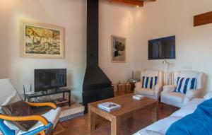a living room with a fireplace with chairs and a table at Villa Maria De Betlem in Colonia de Sant Pere +29 photos