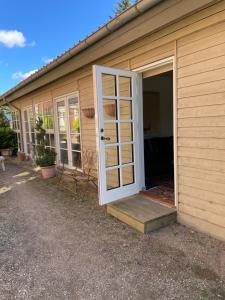 an open door to a house with a porch at Carlsminde ferielejlighed in Stenstrup