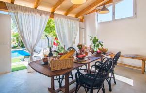 a dining room with a wooden table and chairs at Casa Gema in El Port de la Selva