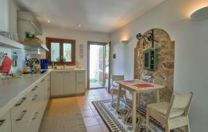 a kitchen with a table and a stone wall at Maria Angela in Artá