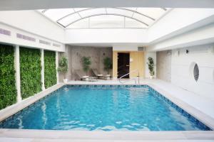 an indoor swimming pool with a glass ceiling at Hotel Nice Riviera in Nice