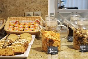 a table with jars of bread and other food at Hotel Nice Riviera in Nice +52 photos