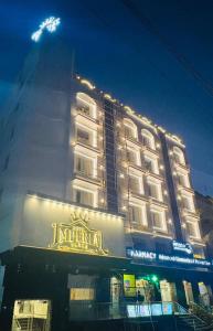a large hotel building with a sign on it at Hotel Imperial Plaza Asansol in Āsansol
