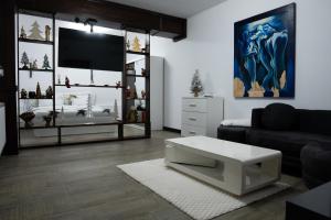 a living room with a couch and a tv at Carul cu Flori in Craiova