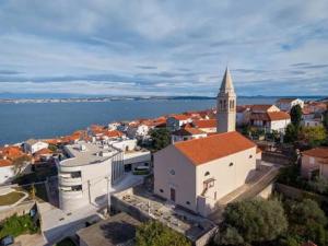 an aerial view of a town with a church and water at Island dream in Kali