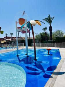 a swimming pool with a water park with a water slide at Casa Moolio - Private Holiday Home with Pool Access, Walk to Beach & Restaurants in Los Alcázares