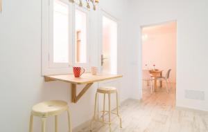 a kitchen with a table and two stools at Convent in Alcudia