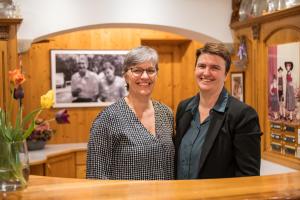 a man and a woman standing next to a table at Hotel Sittnerhof in Merano +48 photos