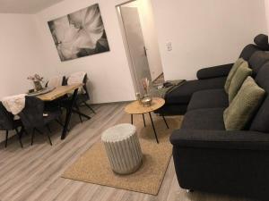 a living room with a couch and a table at Naturnest Berzbuir in Düren - Eifel