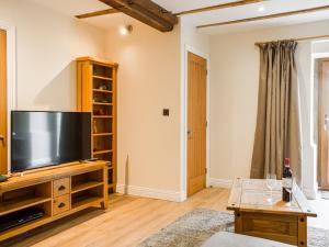a living room with a large flat screen tv at Wheelwright Cottage in Clunbury