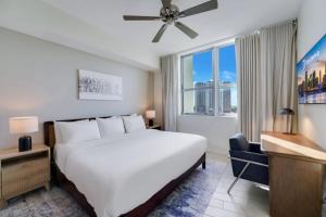a bedroom with a large white bed and a window at Circ Hotel in Hollywood