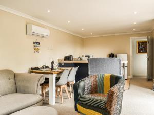 a living room with a table and chairs at The Stables in Edmondsham