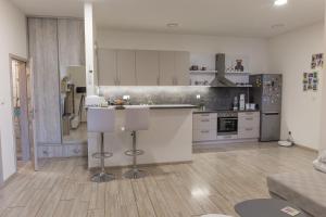 a kitchen with white cabinets and a counter top at Iglovia apartman in Spišská Nová Ves +11 photos