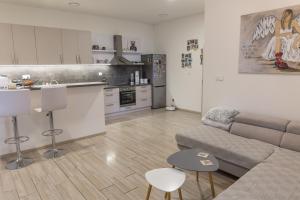 a living room with a couch and a kitchen at Iglovia apartman in Spišská Nová Ves