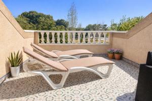 a pair of chairs sitting on a patio at Casa Moolio - Private Holiday Home with Pool Access, Walk to Beach & Restaurants in Los Alcázares