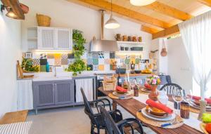 a kitchen and dining room with a table and chairs at Casa Gema in El Port de la Selva
