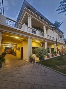 a large building with a balcony on top of it at Ambassador Suites in Dargai