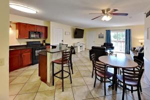 a kitchen and living room with a table and chairs at Put-in-Bay Poolview Condo #6 in Put-in-Bay +15 photos
