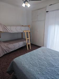 a bedroom with a bunk bed and a ladder at Dpto de Licia in Cipolletti