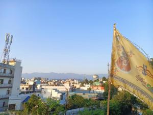a flag flying in front of a city at Independent homestay DDN in Dehradun