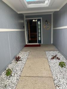 a front door of a home with rocks and plants at Ortona's Best Kept Secret Three-Two Spacious Home in Orlando