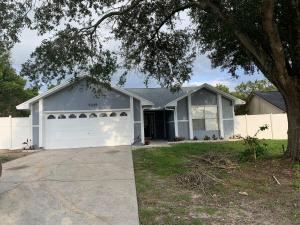 a white house with a white garage at Ortona's Best Kept Secret Three-Two Spacious Home in Orlando