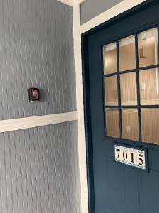 a blue door with a sign in front of it at Ortona's Best Kept Secret Three-Two Spacious Home in Orlando +69 photos