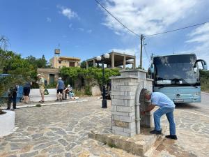 a man leaning into a brick oven in front of a bus at Agali Luxury Home in Khamilón
