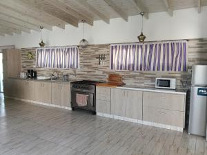 a large kitchen with stainless steel appliances and a stove at Casa Rincon caleta in Mar de Cobo