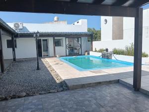 a swimming pool in the backyard of a house at Casa Rincon caleta in Mar de Cobo