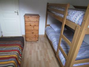 a bedroom with two bunk beds and a dresser at Chalet De Peyrelance in Cauterets