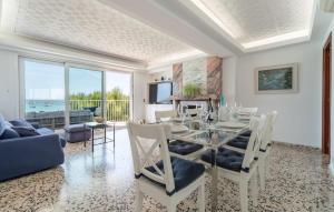 a dining room with a glass table and chairs at Voramar On Pinewalk in Pollença