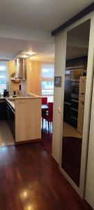 a large kitchen with a dining room and a table at Apartament Rycerska LUX in Łomża