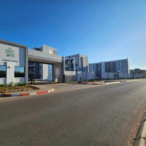 an empty street in front of a building at Naledi Inn in Gaborone