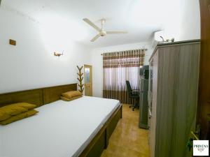 a bedroom with a large white bed in a room at Second Home Resort- Homestay AC Room with Attached Bathroom and WiFi in Boralesgamuwa +21 photos