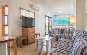 a living room with a couch and a flat screen tv at Marina D'or Lv Casa 5 in Cala d´Or