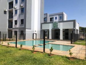 a building with a swimming pool in front of a building at Naledi Inn in Gaborone