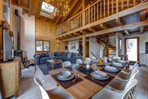 a dining room and living room with a table and chairs at Chalet Renard Roux in La Tzoumaz