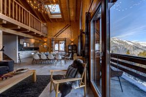 a living room with a view of the mountains at Chalet Renard Roux in La Tzoumaz