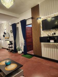 a living room with a television and a table at HA Homes in Matale