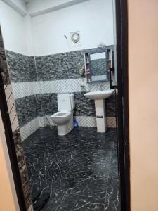 a bathroom with a toilet and a sink at HA Homes in Matale +9 photos